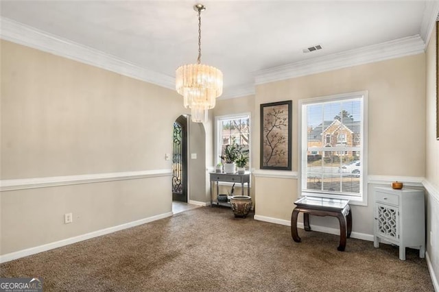 living area featuring carpet floors, ornamental molding, and a chandelier