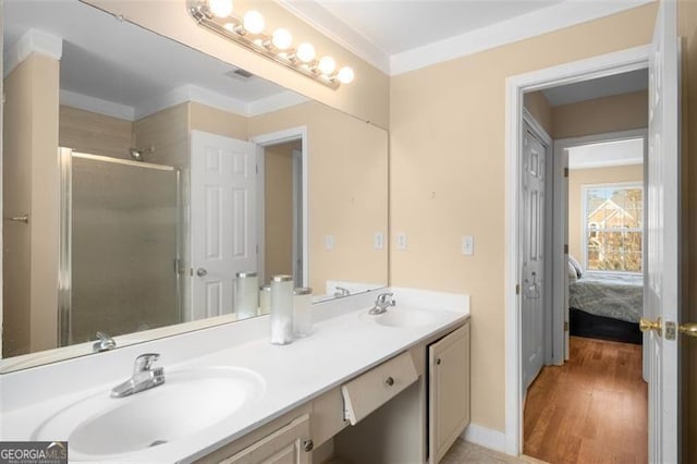 bathroom with hardwood / wood-style floors, walk in shower, vanity, and ornamental molding