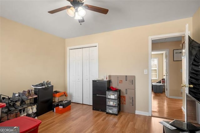 interior space with ceiling fan and light hardwood / wood-style floors