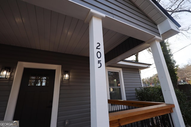 view of exterior entry featuring covered porch