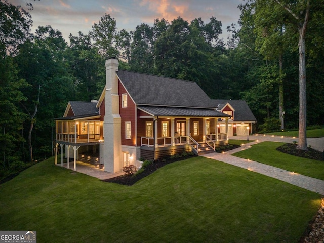 back house at dusk with a yard