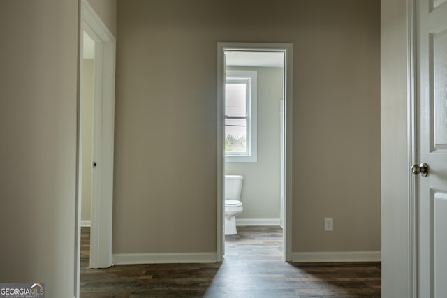 bathroom featuring baseboards, toilet, and wood finished floors