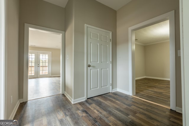 hallway with dark wood-style floors, french doors, and baseboards