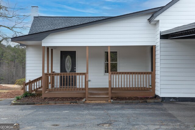 rear view of house with a yard and a wooden deck