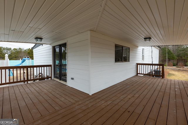 wooden terrace with a playground