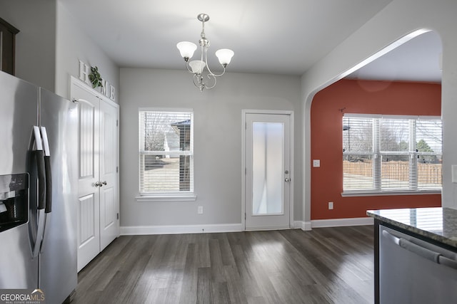 interior space featuring dark hardwood / wood-style floors and an inviting chandelier