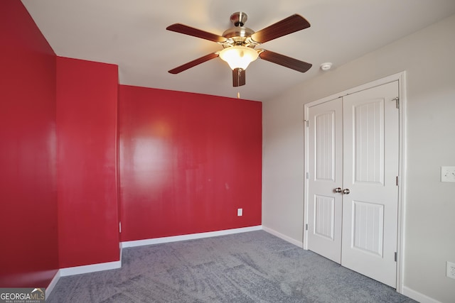 unfurnished bedroom featuring ceiling fan, carpet, and a closet