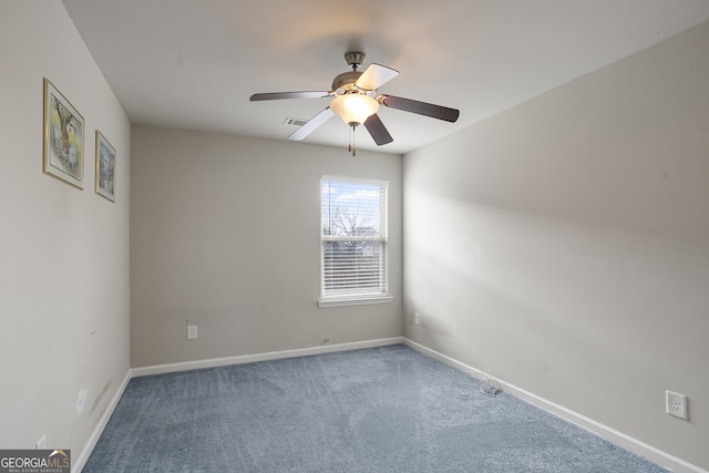 carpeted spare room with ceiling fan