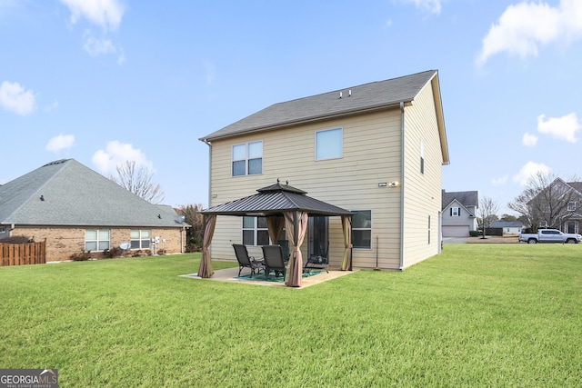 rear view of house with a gazebo, a lawn, and a patio