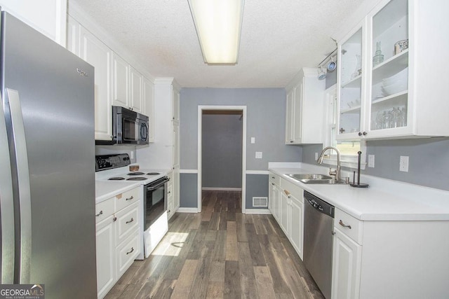 kitchen with a textured ceiling, white cabinets, stainless steel appliances, sink, and dark hardwood / wood-style floors