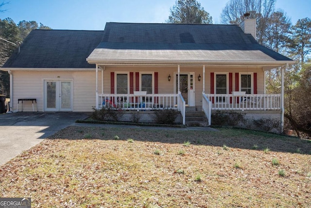 view of front of house with french doors, a porch, and a garage