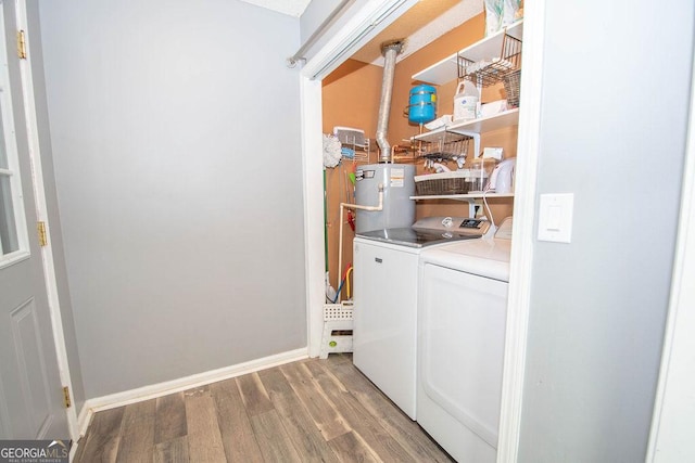 laundry room with hardwood / wood-style floors, water heater, and washing machine and clothes dryer