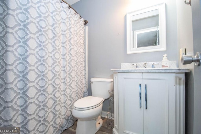 bathroom featuring toilet and vanity