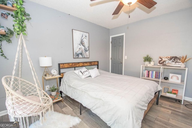 bedroom featuring ceiling fan and wood-type flooring