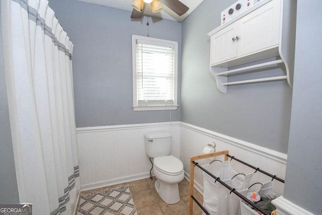 bathroom featuring toilet, ceiling fan, and tile patterned flooring