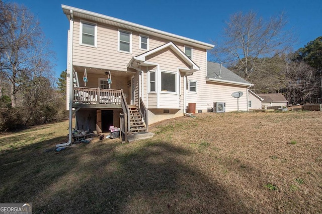 rear view of property featuring a lawn and central air condition unit