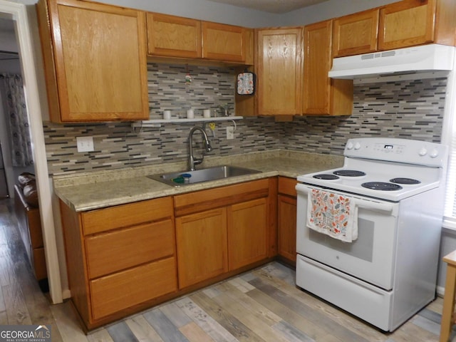 kitchen featuring decorative backsplash, light hardwood / wood-style flooring, electric range, and sink