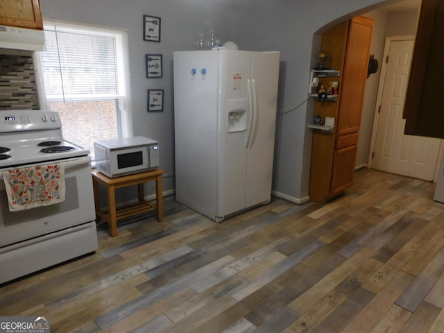 kitchen with dark hardwood / wood-style flooring, white appliances, and a notable chandelier