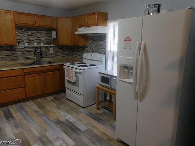 kitchen featuring tasteful backsplash, dark hardwood / wood-style floors, sink, and white appliances