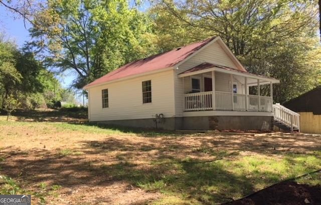 view of property exterior featuring a porch