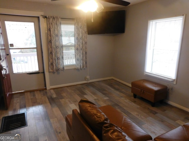 interior space featuring ceiling fan and dark hardwood / wood-style flooring