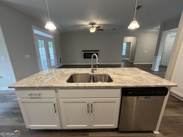 143 Madeira Dr, Brunswick, GA 31523 - kitchen featuring stainless steel dishwasher, a sink, open floor plan, a ceiling fan, and light stone countertops