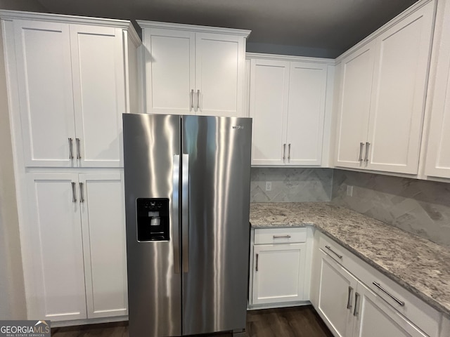 143 Madeira Dr, Brunswick, GA 31523 - kitchen featuring stainless steel fridge, white cabinetry, tasteful backsplash, light stone counters, and dark wood-type flooring
