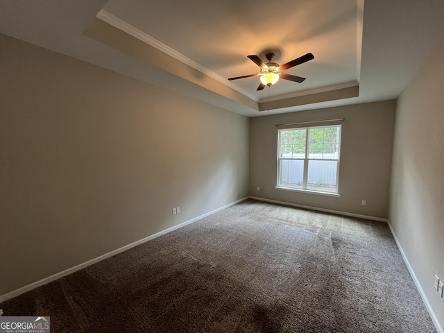 143 Madeira Dr, Brunswick, GA 31523 - empty room with a raised ceiling, carpet floors, ceiling fan, crown molding, and baseboards