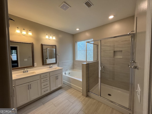 143 Madeira Dr, Brunswick, GA 31523 - full bathroom with a bath, double vanity, a shower stall, and recessed lighting