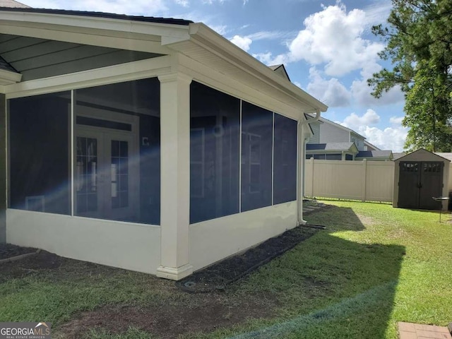 view of side of home featuring a yard and a sunroom