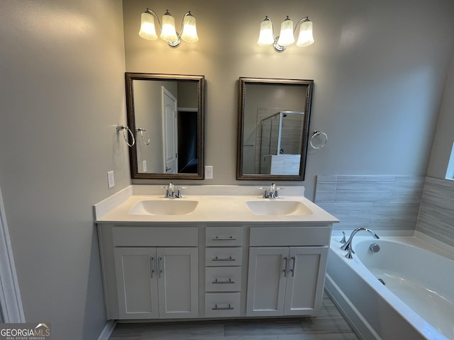 143 Madeira Dr, Brunswick, GA 31523 - bathroom with a garden tub, double vanity, and a shower stall
