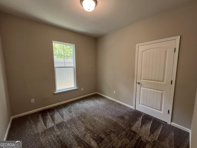 143 Madeira Dr, Brunswick, GA 31523 - spare room featuring dark colored carpet and baseboards