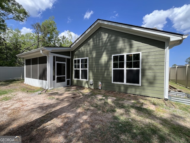 143 Madeira Dr, Brunswick, GA 31523 - back of house featuring a sunroom