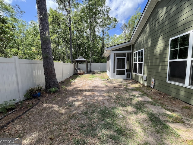 143 Madeira Dr, Brunswick, GA 31523 - fenced backyard with a sunroom and a gazebo