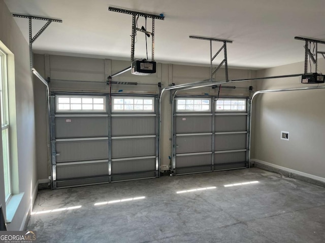 143 Madeira Dr, Brunswick, GA 31523 - garage featuring a garage door opener and baseboards
