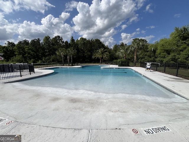 143 Madeira Dr, Brunswick, GA 31523 - community pool with view of wooded area and a patio