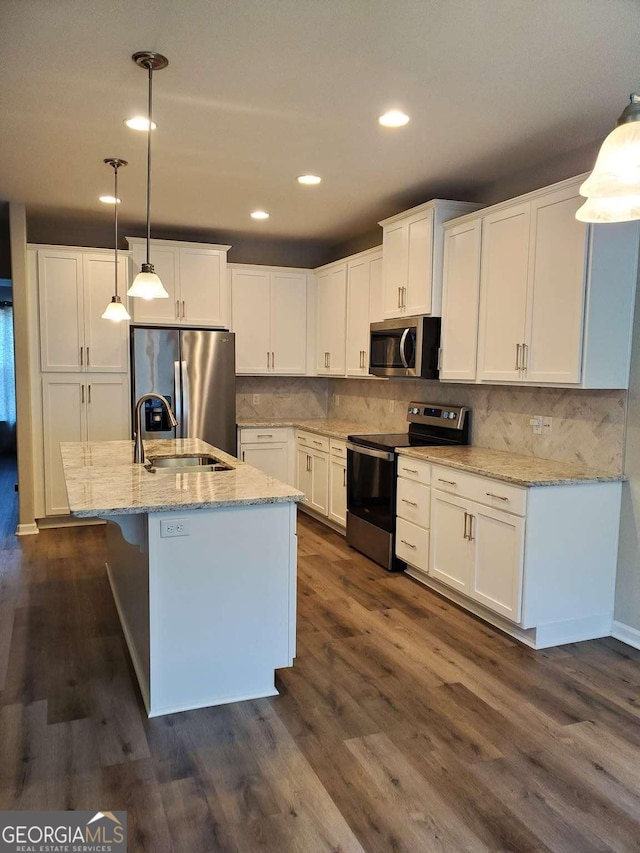 kitchen featuring hanging light fixtures, white cabinets, dark hardwood / wood-style floors, and stainless steel appliances