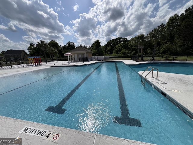 143 Madeira Dr, Brunswick, GA 31523 - community pool with view of wooded area and a patio