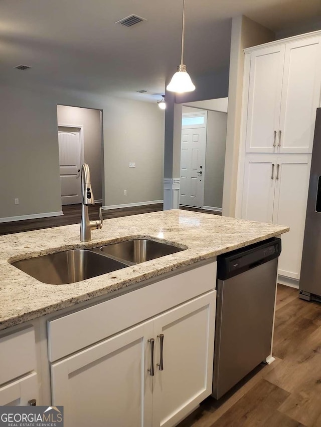 kitchen with decorative light fixtures, sink, white cabinetry, light stone countertops, and stainless steel appliances