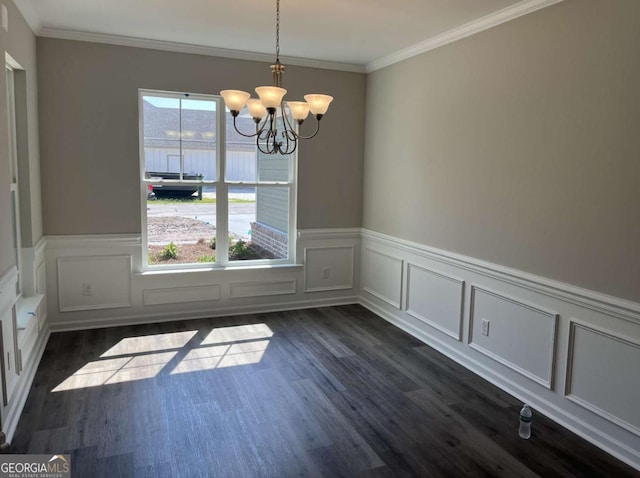 unfurnished dining area with dark hardwood / wood-style floors, ornamental molding, and a notable chandelier