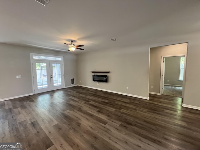 143 Madeira Dr, Brunswick, GA 31523 - unfurnished living room featuring french doors, dark wood-style flooring, ceiling fan, and baseboards
