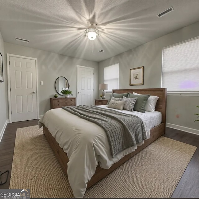 bedroom featuring dark hardwood / wood-style flooring and ceiling fan