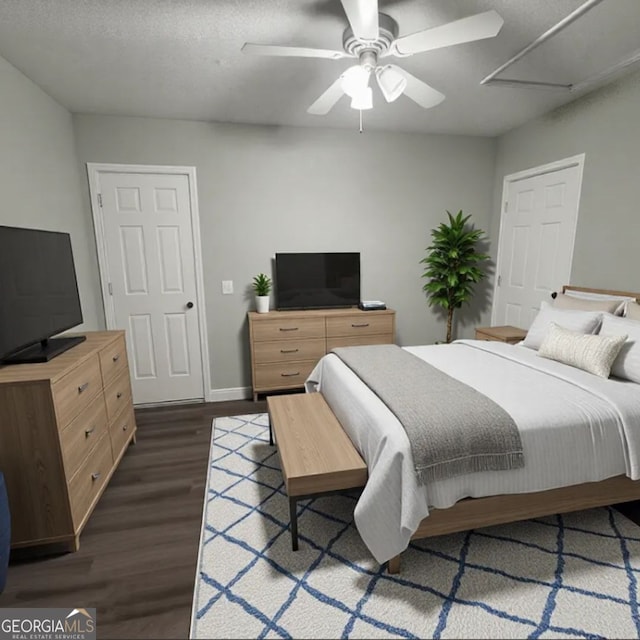 bedroom featuring dark hardwood / wood-style flooring, a textured ceiling, and ceiling fan