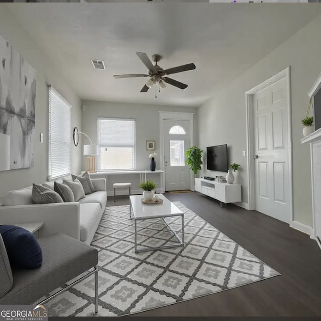 living room with dark wood-type flooring and ceiling fan