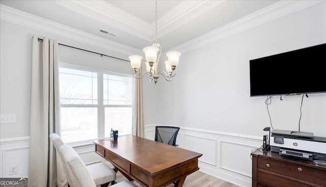 home office with a healthy amount of sunlight, an inviting chandelier, crown molding, and light hardwood / wood-style floors