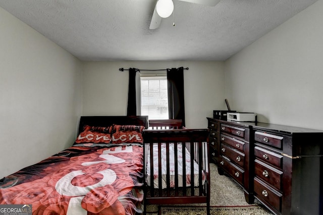 bedroom featuring light colored carpet, a textured ceiling, and ceiling fan