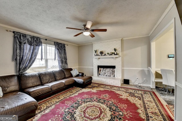 living room featuring ceiling fan, crown molding, a fireplace, and a textured ceiling