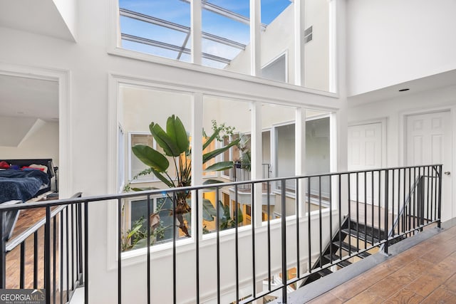 hallway with a wealth of natural light and hardwood / wood-style flooring