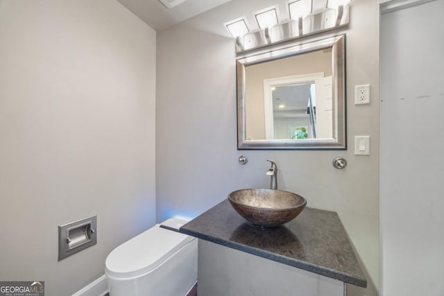 bathroom featuring toilet and vanity