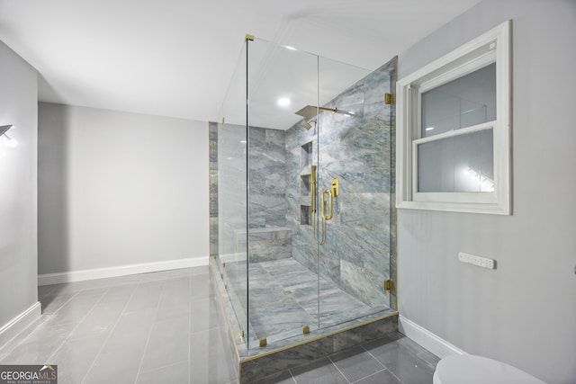 bathroom with a shower with shower door and tile patterned floors